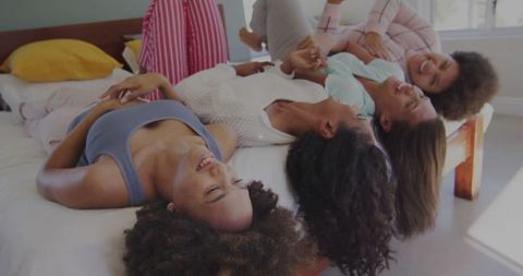 Group of Friends Having Fun in Bedroom Pajama Party