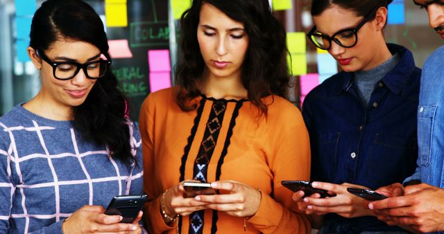 Young Multiracial Team Working on Individual Smartphones in Modern Office - Download Free Stock Images Pikwizard.com