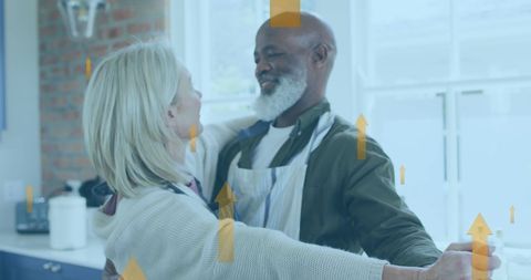 Diverse couple dancing in kitchen embracing relationship growth
