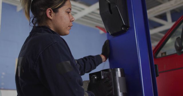 Female Mechanic Examining Automotive Equipment in a Workshop - Download Free Stock Images Pikwizard.com