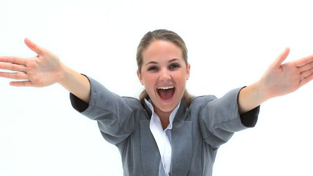 Businesswoman presenting joyful demeanor, wearing a gray suit and extending arms forward. Perfect for business promotions, representing success, enthusiasm, positive workplace environment, or expressing welcoming attitude.