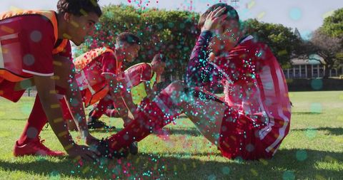 Teen athletes warming up on soccer field with team support