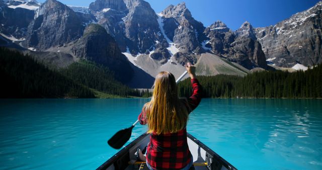 Woman Paddling Canoe in Lake Surrounded by Majestic Mountains - Download Free Stock Photos Pikwizard.com