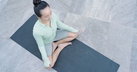 Woman Meditating Outdoors in Serene Ambiance