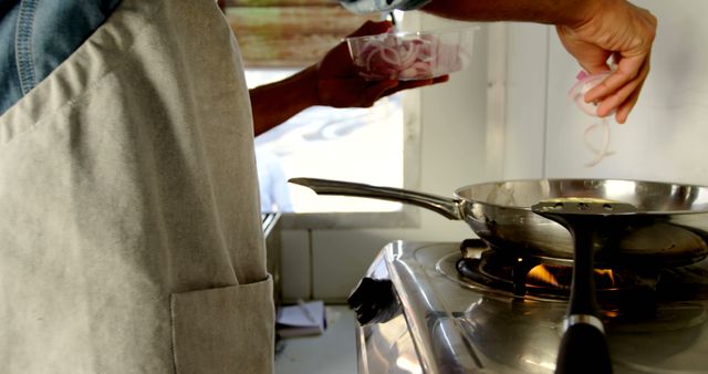 Person Cooking On Stovetop Adding Ingredients to Frying Pan - Download Free Stock Images Pikwizard.com