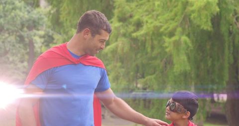 Father and Son Bonding in Superhero Costumes Outdoors