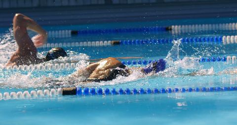 Athletes Practicing Freestyle Stroke in Competitive Pool