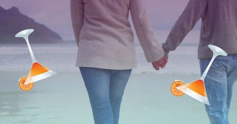 Romantic Walk: Couple Holding Hands by the Sea with Cocktail Graphics