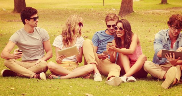 Group of Friends Relaxing on Grass with Technological Devices - Download Free Stock Images Pikwizard.com