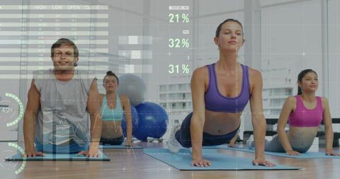 Group practicing upward-facing dog yoga in studio, stretching with fitness data overlay