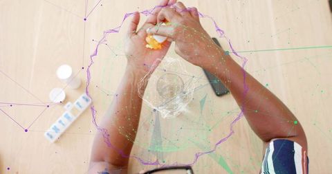 Senior woman peeling boiled egg at kitchen with pillbox and smartphone, medication care