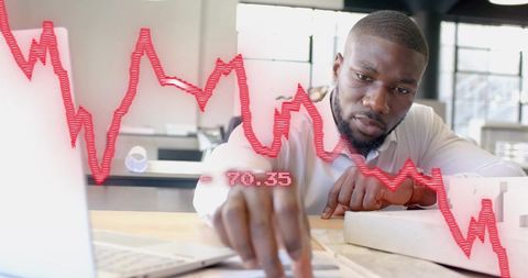 Businessman analyzing financial decline in modern office