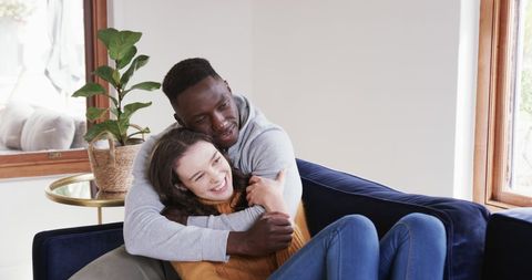 Happy Interracial Couple Relaxing in Modern Living Room - Download Free Stock Images Pikwizard.com