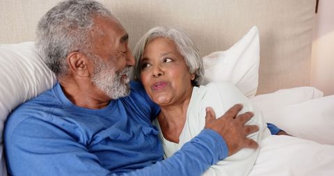 Elderly Couple Embracing in Bed, Enjoying Togetherness and Love