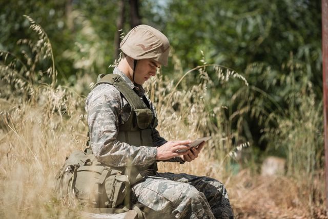 Military soldier using digital tablet in boot camp