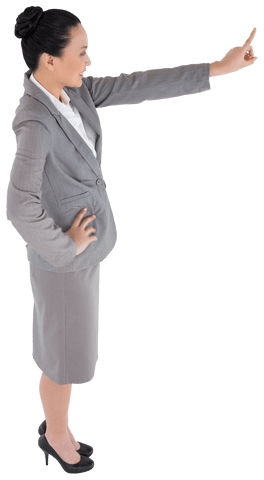 This image of a smiling Asian businesswoman confidently pointing with finger is perfect for presentations, marketing materials, or websites focused on business growth, leadership, or corporate culture. The transparency allows seamless integration into various designs, highlighting professionalism and modernity.