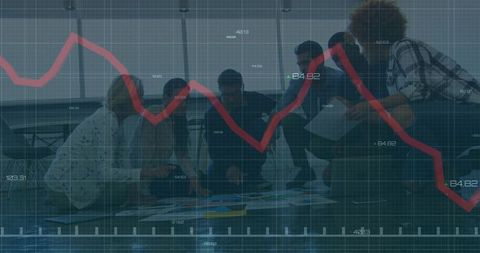 Business team analyzing data with projected red line graph overlay