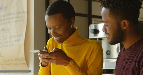 African American Young Adults Sharing Fun Smartphone Moments