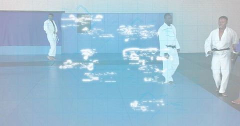 Martial Artists Performing Flying Kicks in Dojo with Futuristic Digital Overlay
