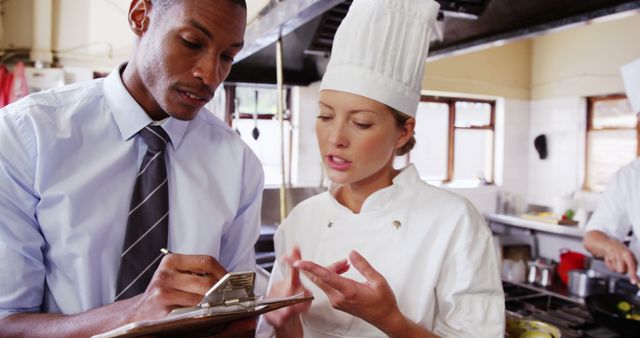 Restaurant Manager Talking With Female Chef In Industrial Kitchen - Download Free Stock Images Pikwizard.com