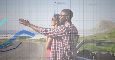 Couple roadtripping, pointing toward ocean horizon with financial travel chart overlay