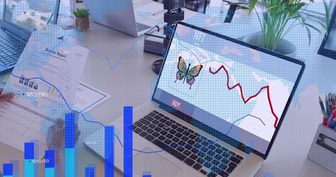 Analyst reviewing falling charts on laptop while holding report with buy signal