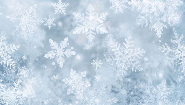 Floating snowflakes and ice crystals with soft bokeh glow winter background