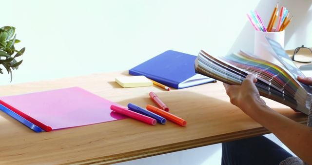 Person Examining Color Swatches at a Desk with Supplies - Download Free Stock Images Pikwizard.com