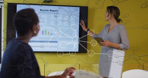 Business Presenter Pointing at Quarter Report Slide with Tablet and Network Diagram