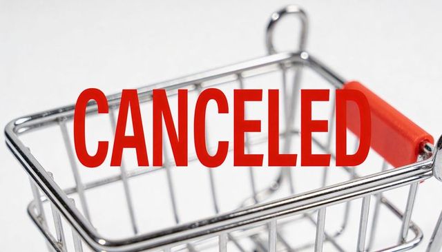 Displaying canceled label on mini metal shopping cart with red handle for retail concepts