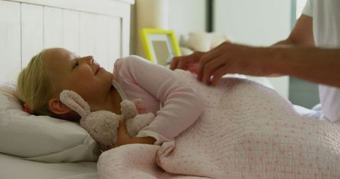 Father Gently Waking Daughter with a Lovable Toy