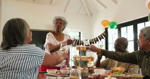 Joyful Senior Friends Celebrating Retirement Party with Toast