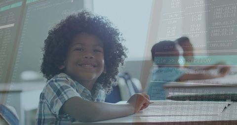 Curly-haired boy learning coding and cryptography in bright classroom with data overlay