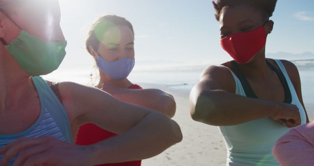 Group of Friends Elbow Bumping While Wearing Masks at Beach - Download Free Stock Images Pikwizard.com