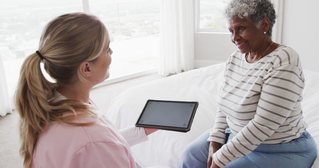 Senior Woman Consulting with Health Professional at Home - Download Free Stock Images Pikwizard.com