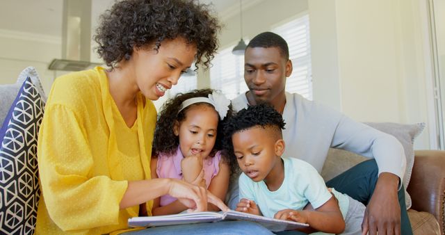 Family spending quality time together at home, reading a book with their children. Perfect for use in parenting blogs, educational materials, family activities promotion, and articles on family bonding.