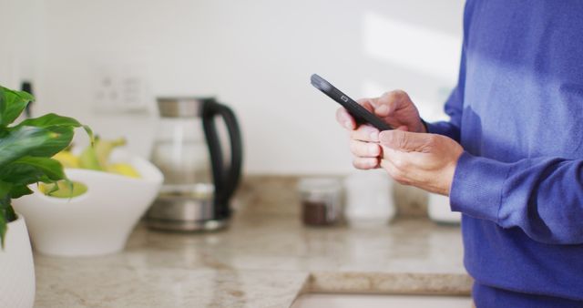 Person Using Smartphone in Modern Kitchen - Download Free Stock Images Pikwizard.com