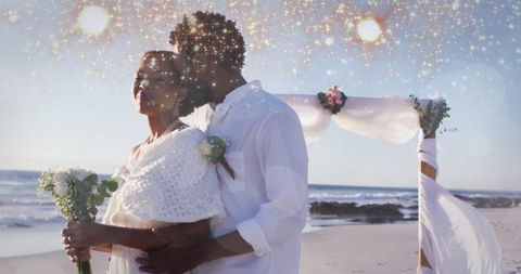 Romantic Seaside Wedding with Multiracial Couple Embracing During Sunset