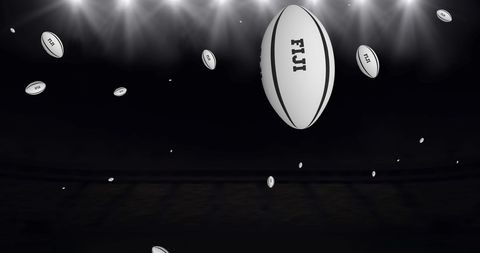 Rugby balls hovering in stadium spotlight against dark background