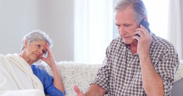 Focused elderly couple calling doctor at home - Download Free Stock Photos Pikwizard.com