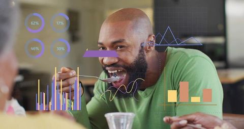 Smiling man eating at table with colorful data visualization overlays and analytic charts