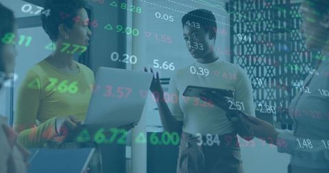 Women Collaborating on Financial Analytics in Modern Office