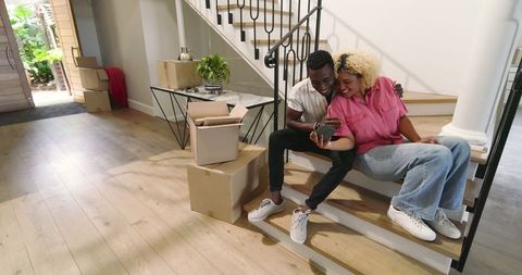 Friends Taking Selfie on Stairs During Shared Moving Day Adventure