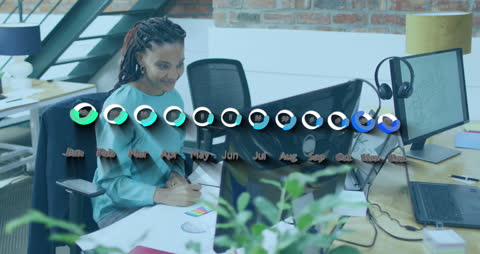 Businesswomen Analyzing Monthly Financial Data in Modern Office