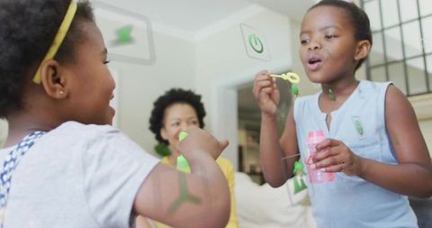 Children Blowing Bubbles Indoors with Futuristic Touchscreen Interface