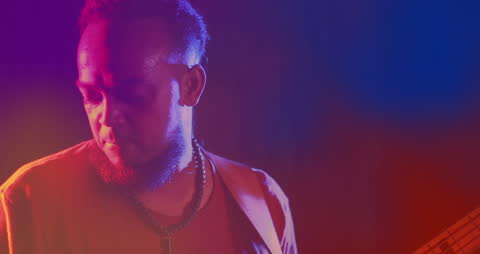 Animated lights blending while bass guitarist performs on stage