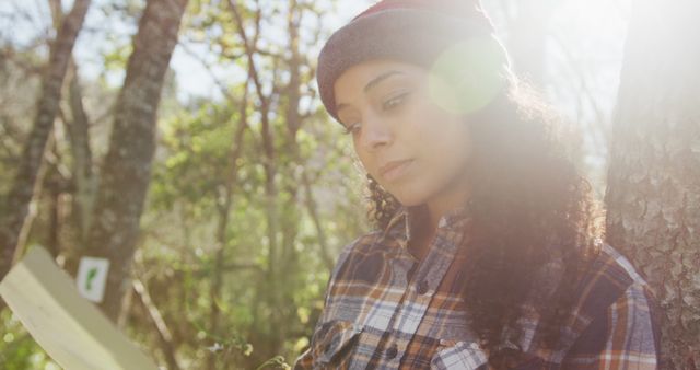 Outdoor Reading in Sunlight by Young Woman with Curly Hair - Download Free Stock Images Pikwizard.com