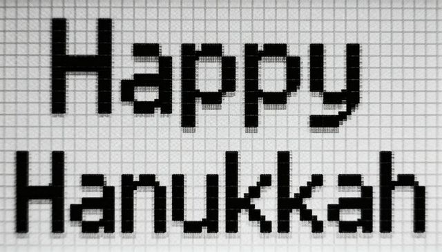 Happy hanukkah pixel typography on graph paper monochrome grid retro 8-bit greeting