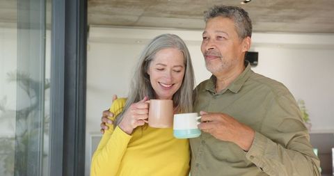 Happy Senior Couple Enjoying Cozy Morning with Coffee at Home