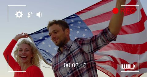 Happy Couple Enjoying Freedom with American Flag in Patriotic Spirit